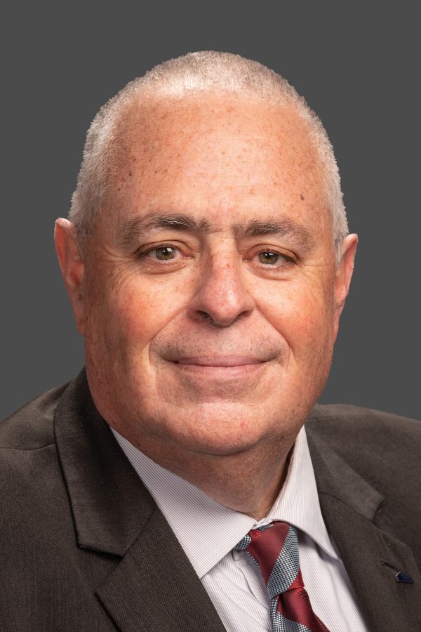 Adult male professional headshot on a blue background