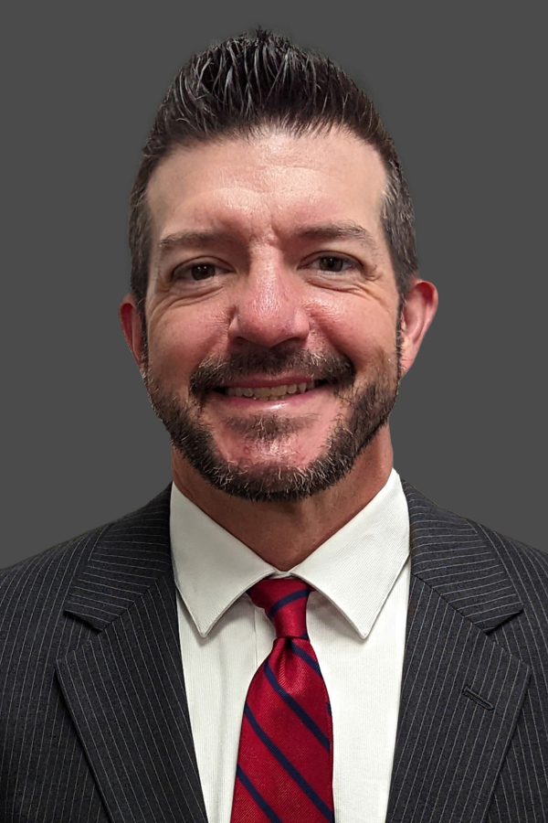 Adult male professional headshot on a blue background