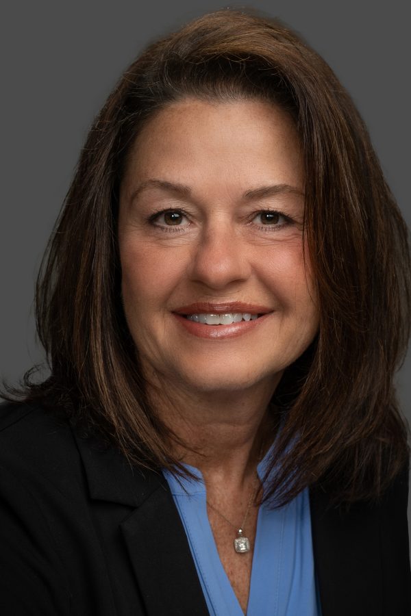 Adult female professional headshot on a blue background