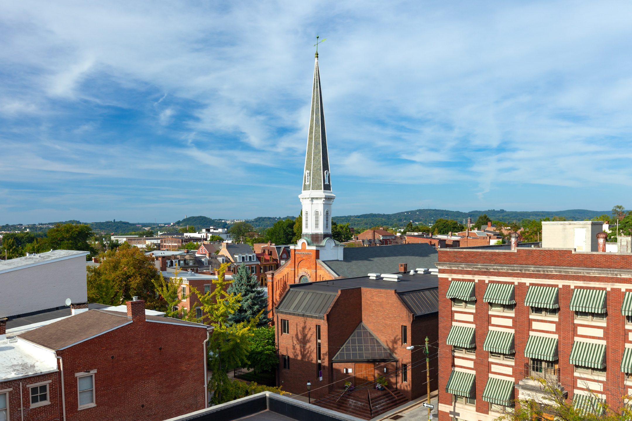 Aerial photo of a city's downtown with a church steeple